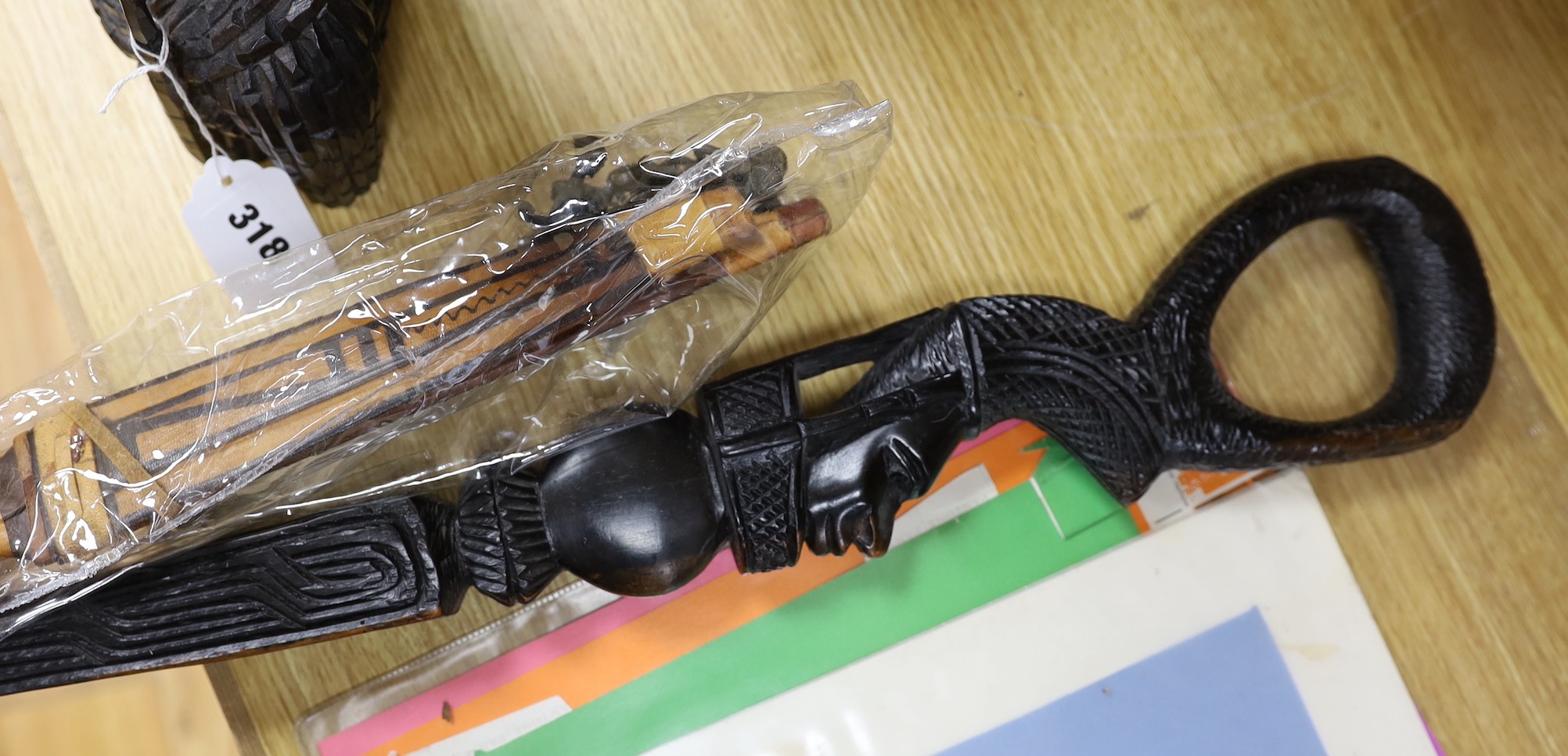 A group of African carvings, and two knives within sheaths, tallest figure 51cm